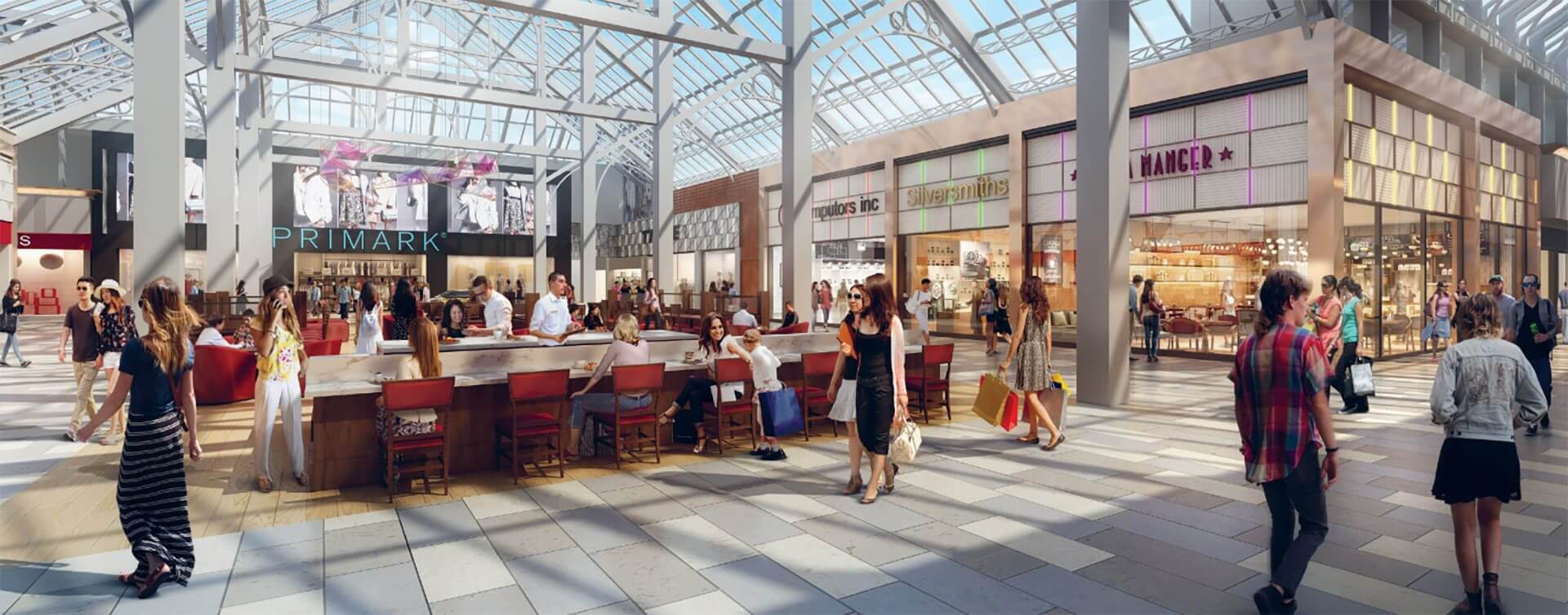 Commercial square in the UK with shops around and restaurant tables in the middle.