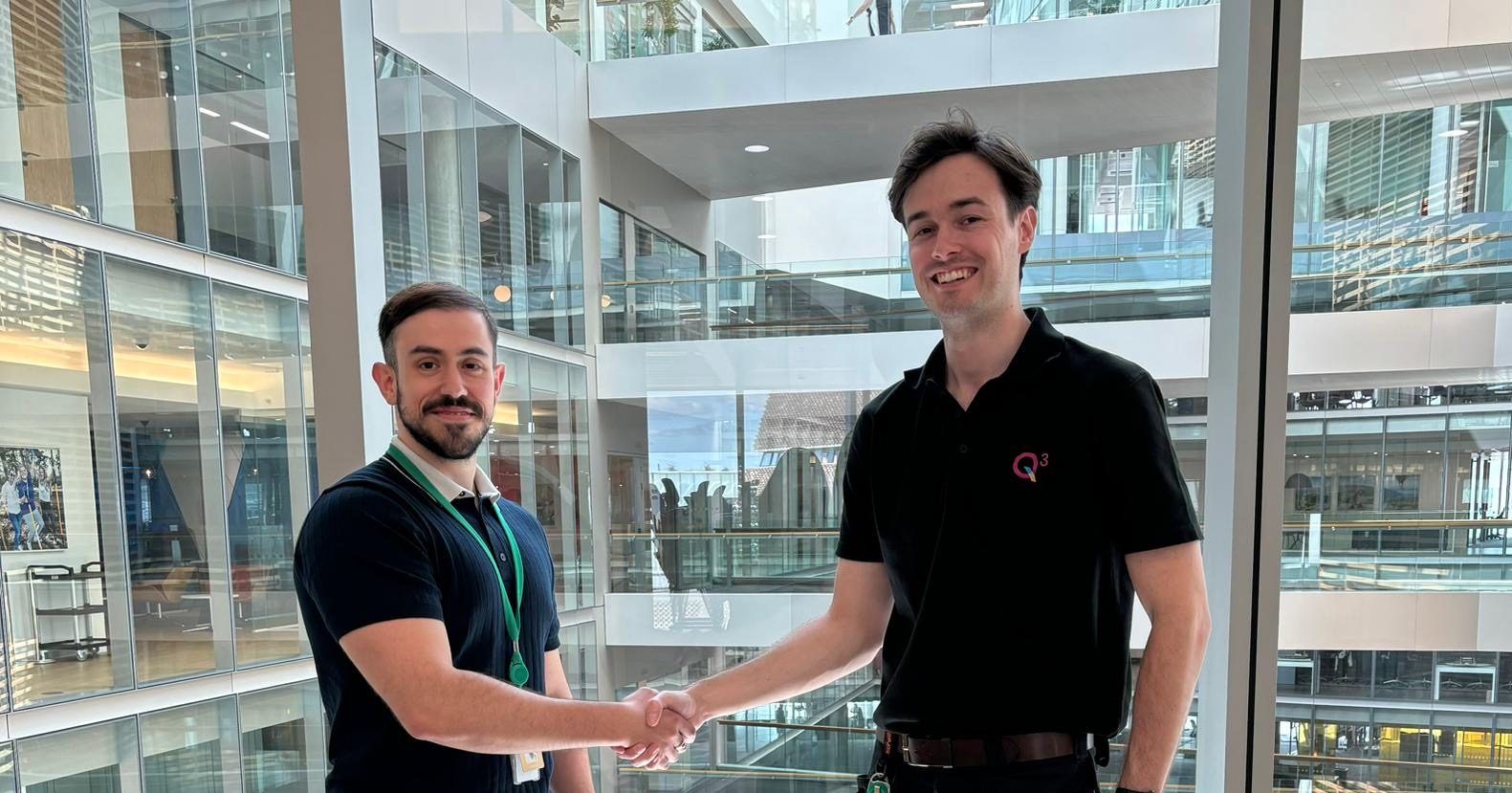 Fabio Groncalves and Joe Trodd, working at Q3, shaking their hands.